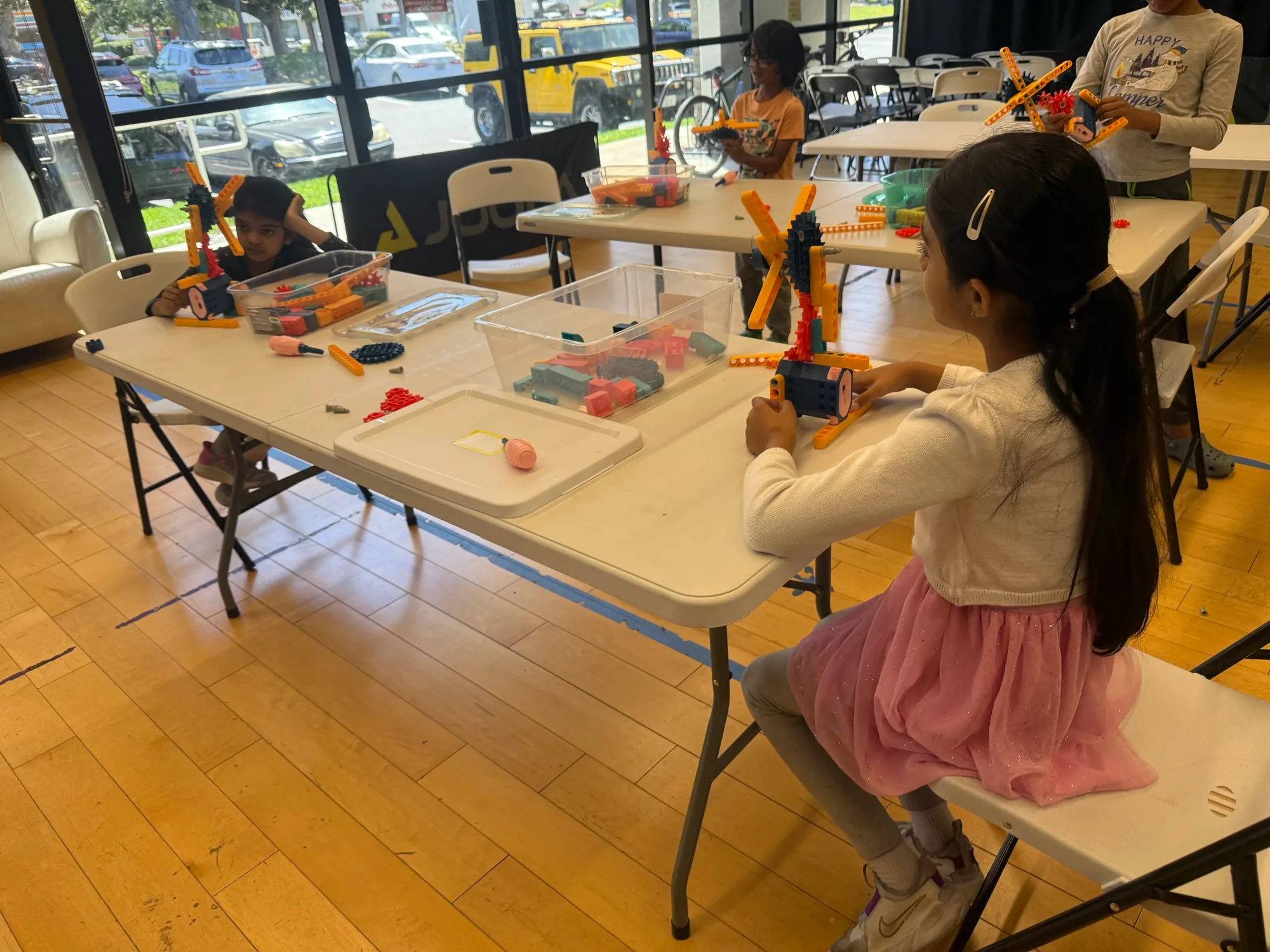 Children building and testing colorful robotics models