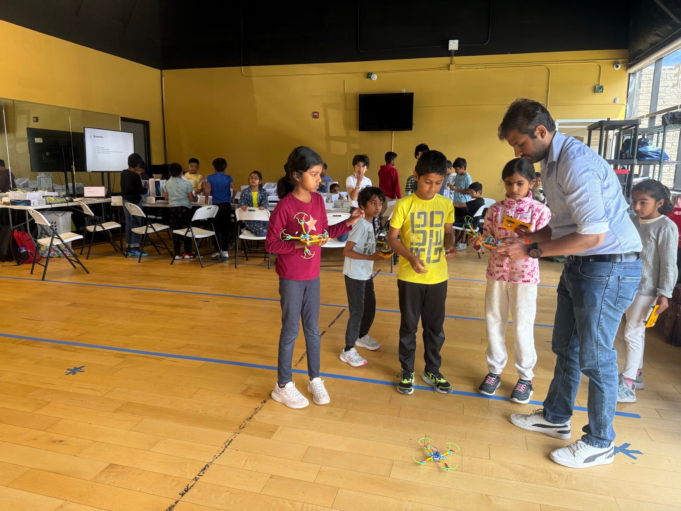 Children presenting their creations with an educator