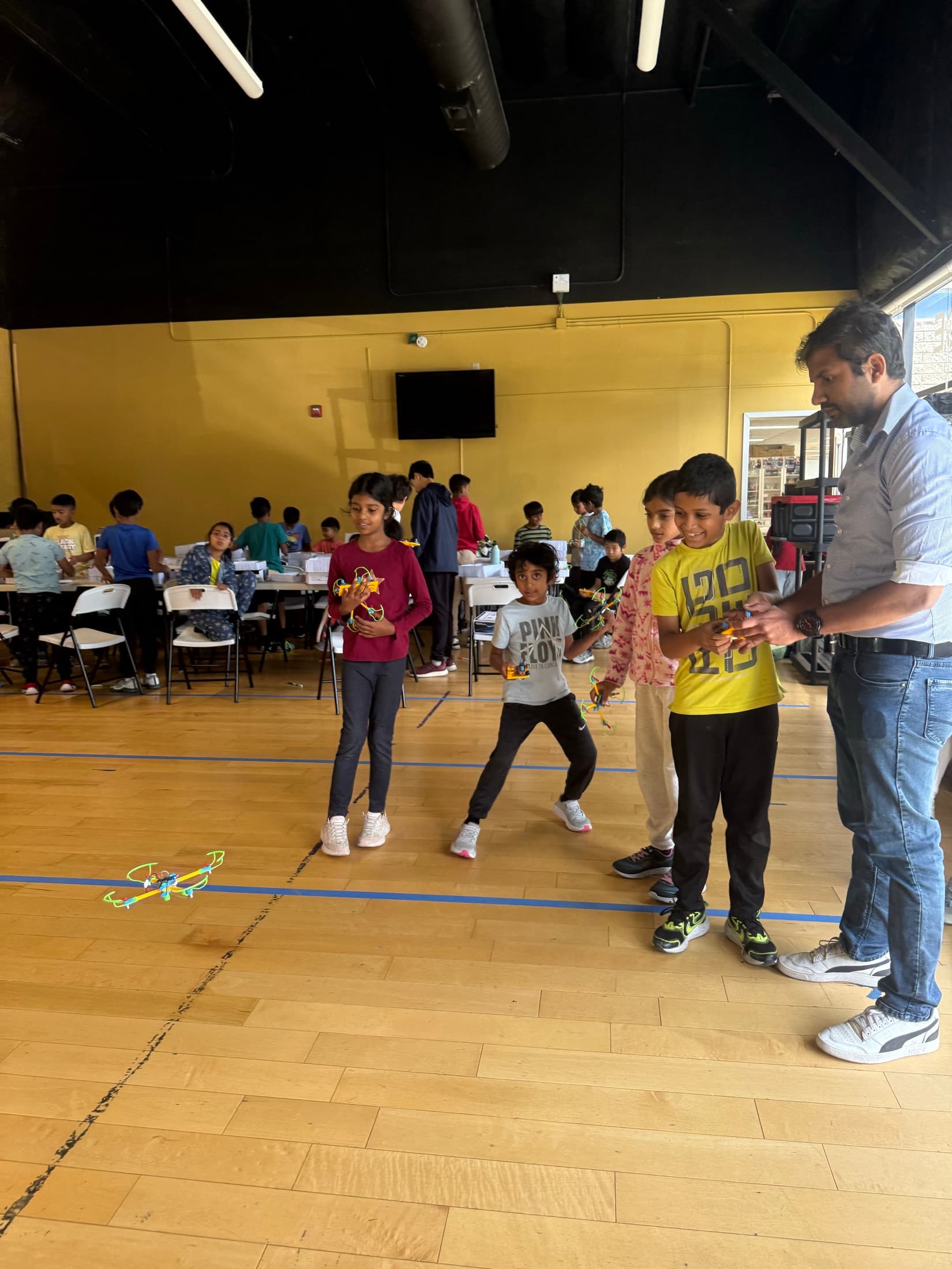 An educator supporting children during a group challenge
