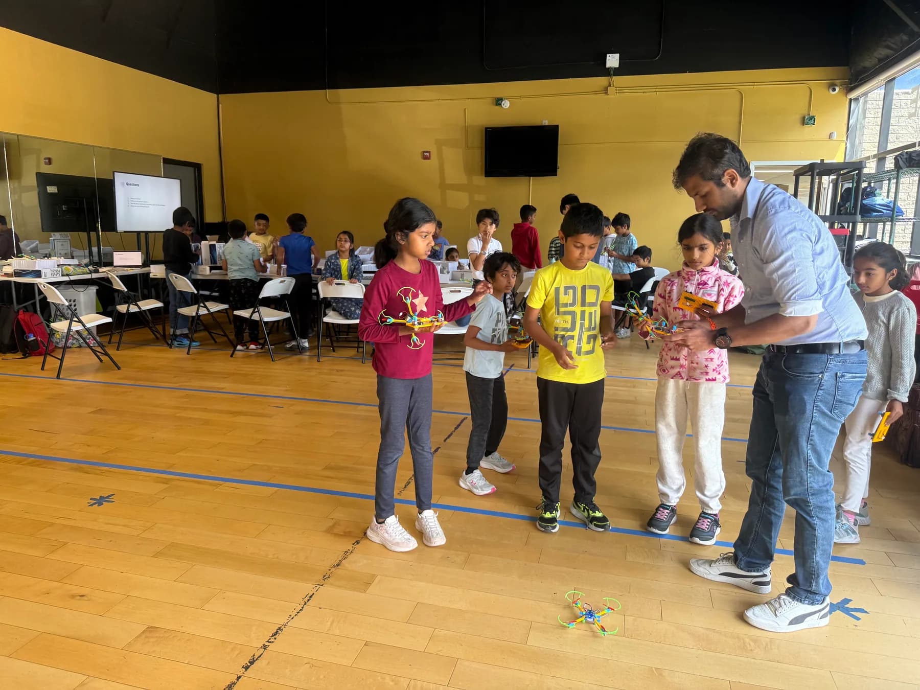 Children working with an educator during a team design challenge